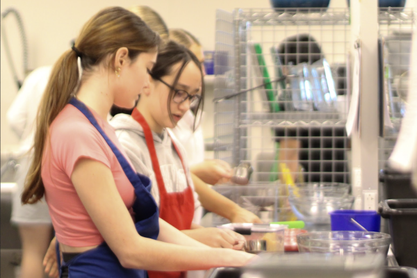 Students cooking in the kitchen during a FACS food class.